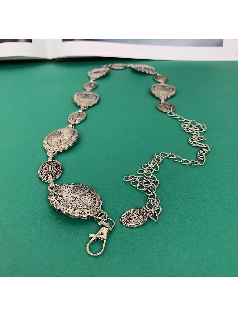Silver western belt with silver buckle and metal sun and moon charms. Fits most